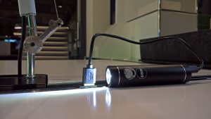 A rechargable USM bike light rechargig in a Haller E USB charger, as seen at USM Haller HomeWork, smow Köln